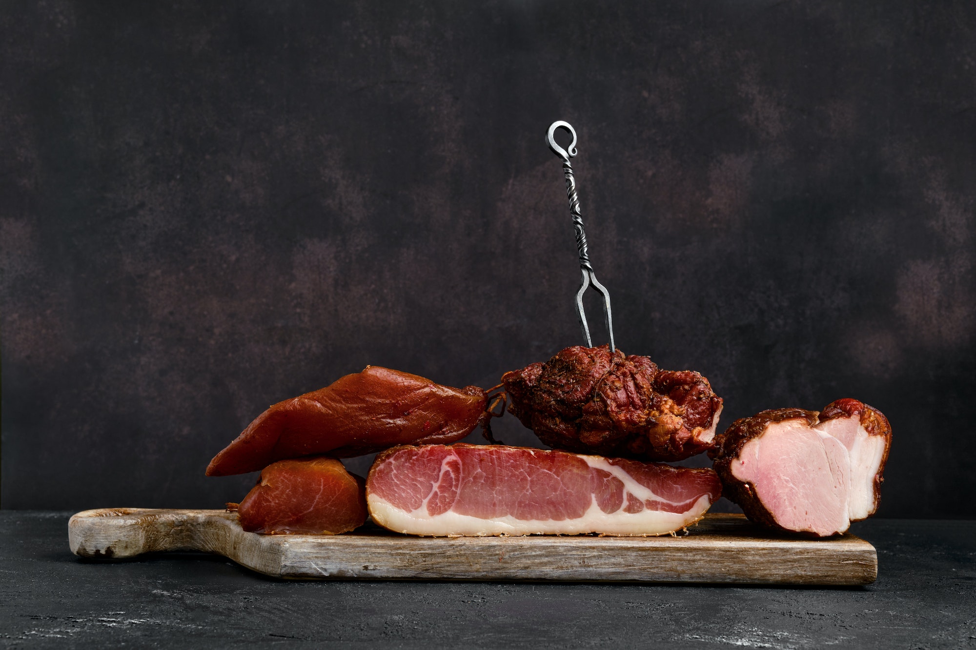 Wooden board with assortment of pork ham